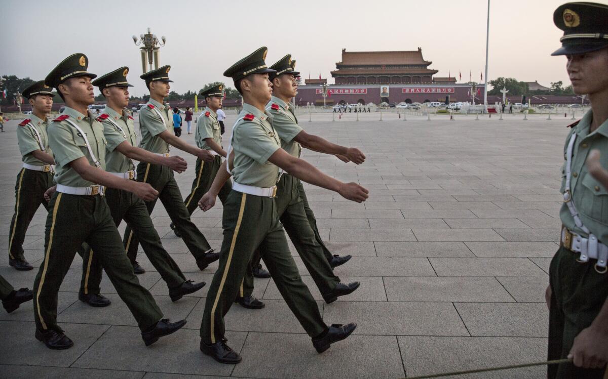 Chinese paramilitary soldiers march in Tiananmen Square in Beijing on Tuesday.