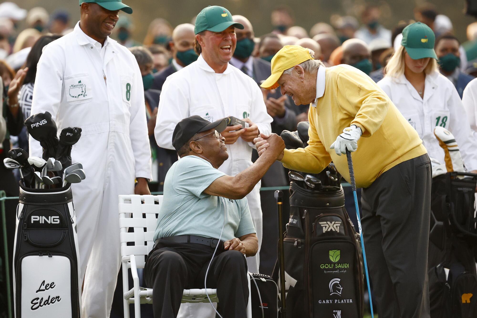 Lee Elder, left, greets Jack Nicklaus on the first tee.