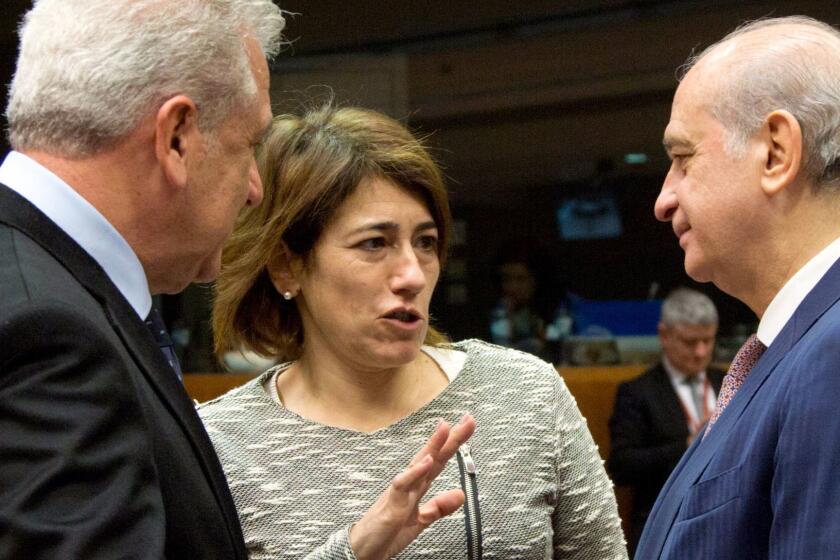 FILE - In this March 10, 2016 file photo, Portuguese Interior Minister Constanca Urbano de Sousa, center, talks with Spanish Interior Minister Jorge Fernandez Diaz, right, and European Commissioner for Migration and Home Affairs Dimitris Avramopoulos, left, during a meeting of EU justice and interior ministers at the EU Council building in Brussels. The Portuguese government minister in charge of emergency services has resigned after 106 people were killed in wildfires this year. The government said on its website on Wednesday Oct. 18, 2017, that Interior Minister Constanca Urbano de Sousa has tendered her resignation and that Prime Minister Antonio Costa has accepted it. (AP Photo/Virginia Mayo)