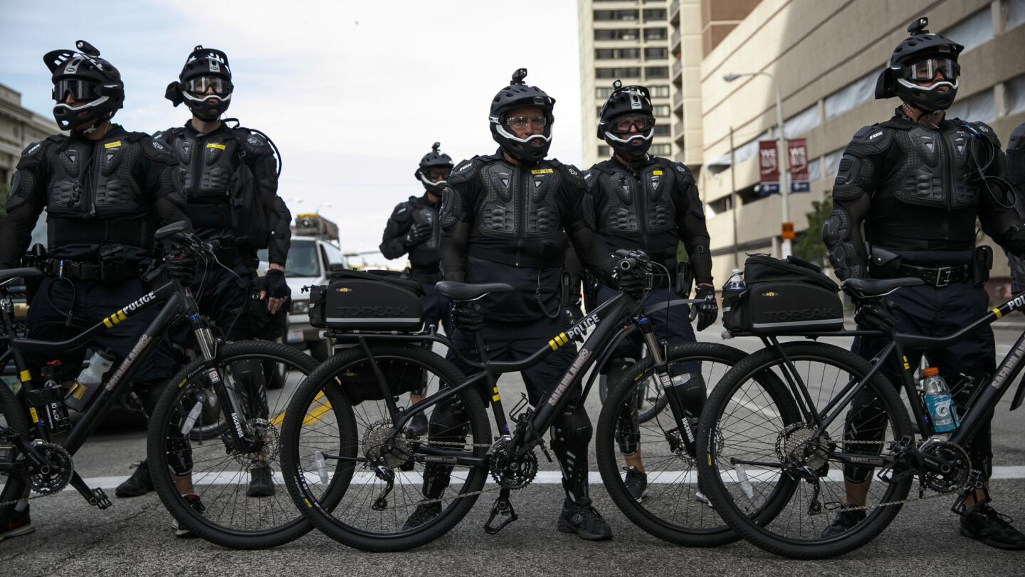 Police officers in protective gear.