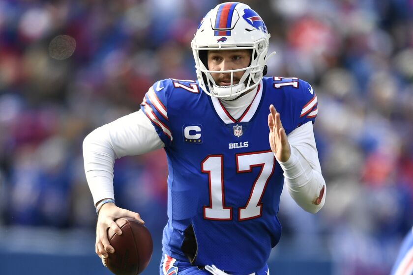 FILE - Buffalo Bills quarterback Josh Allen (17) looks to pass during the first half of an NFL wild-card playoff football game against the Miami Dolphins, Sunday, Jan. 15, 2023, in Orchard Park, N.Y. The three-time AFC East champion Buffalo Bills are suddenly paying for the price of success in entering the NFL draft with several needs, but few selections. (AP Photo/Adrian Kraus, File)