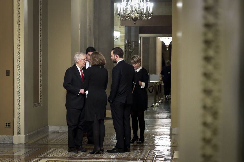 WASHINGTON, DC - JANUARY 22: At nearly 2 o'clock in the morning, Senate Majority Leader Mitch McConnell (R-KY) huddles with staff after the Senate adjourned for the night during the impeachment trial proceedings at the U.S. Capitol on January 22, 2020 in Washington, DC. The Senate impeachment trial of U.S. President Donald Trump will resume on Wednesday at 1:00PM. (Photo by Drew Angerer/Getty Images) ** OUTS - ELSENT, FPG, CM - OUTS * NM, PH, VA if sourced by CT, LA or MoD **