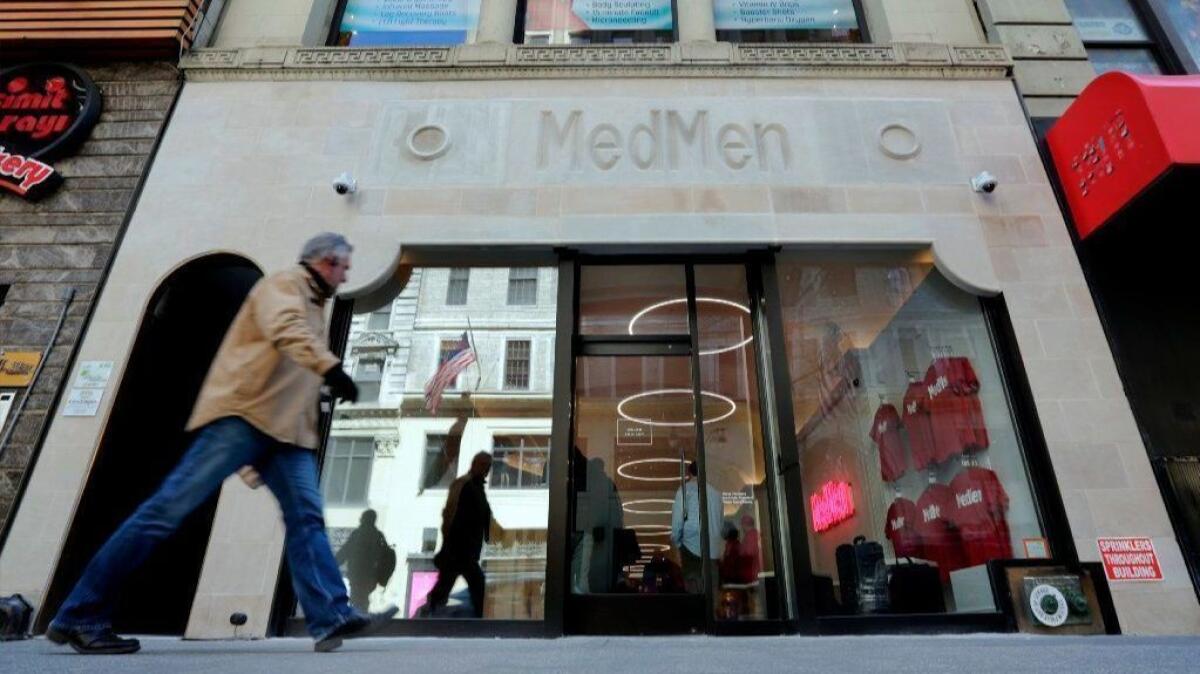 A pedestrian passes the MedMen store on New York's Fifth Avenue. The company operates a dozen cannabis shops and is working on opening three more, including one on the Las Vegas Strip.