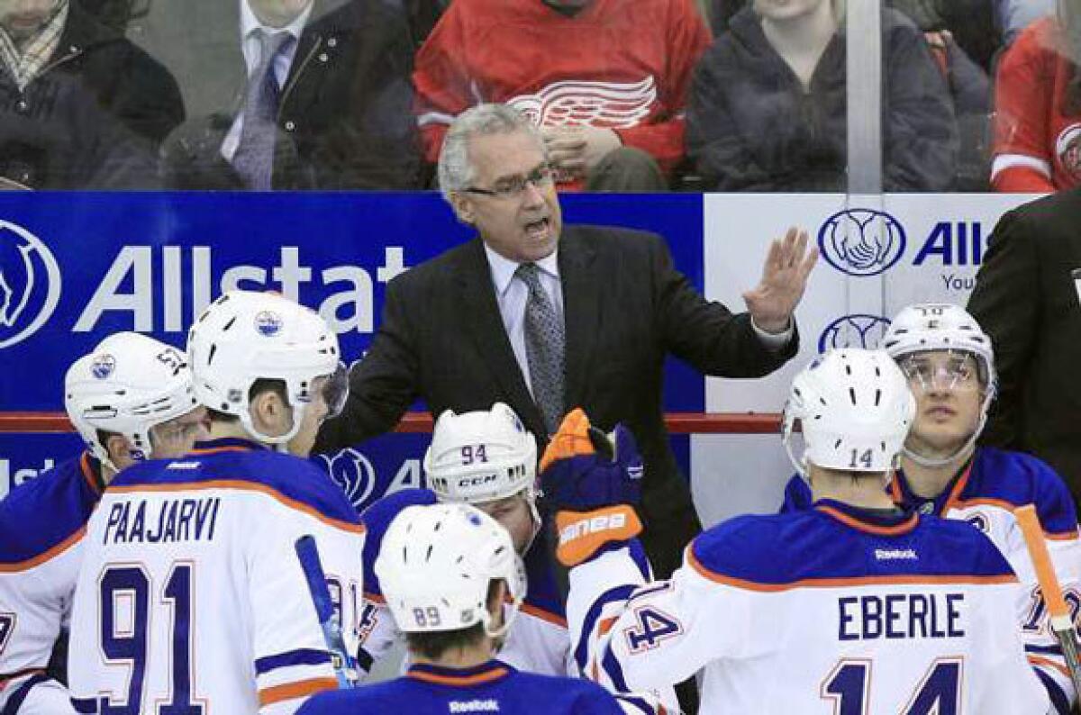 Edmonton Oilers Coach Tom Renney talks to his team during a game against Detroit.