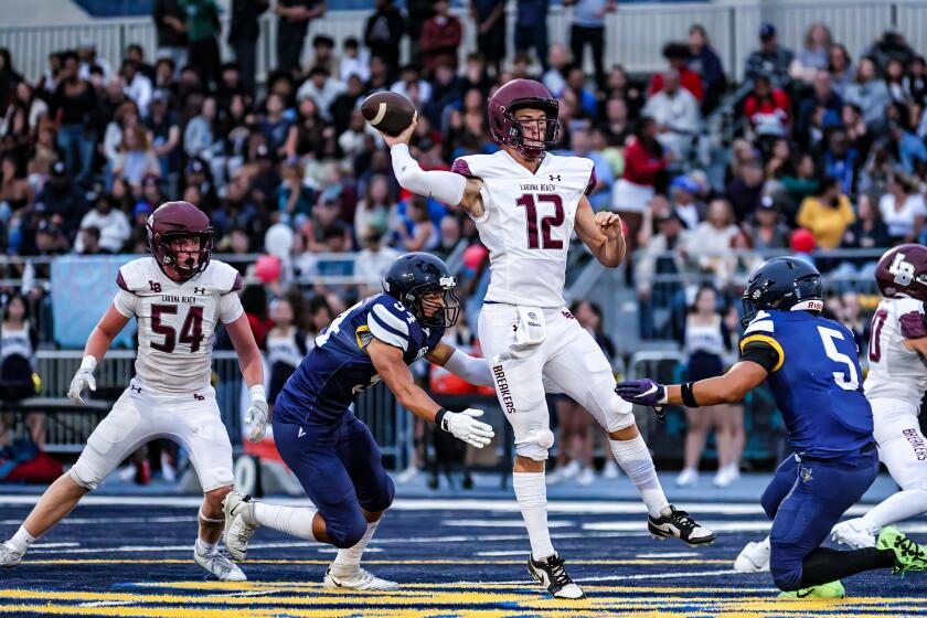 Quarterback Jackson Kollock of Laguna Beach passes against Santa Monica.