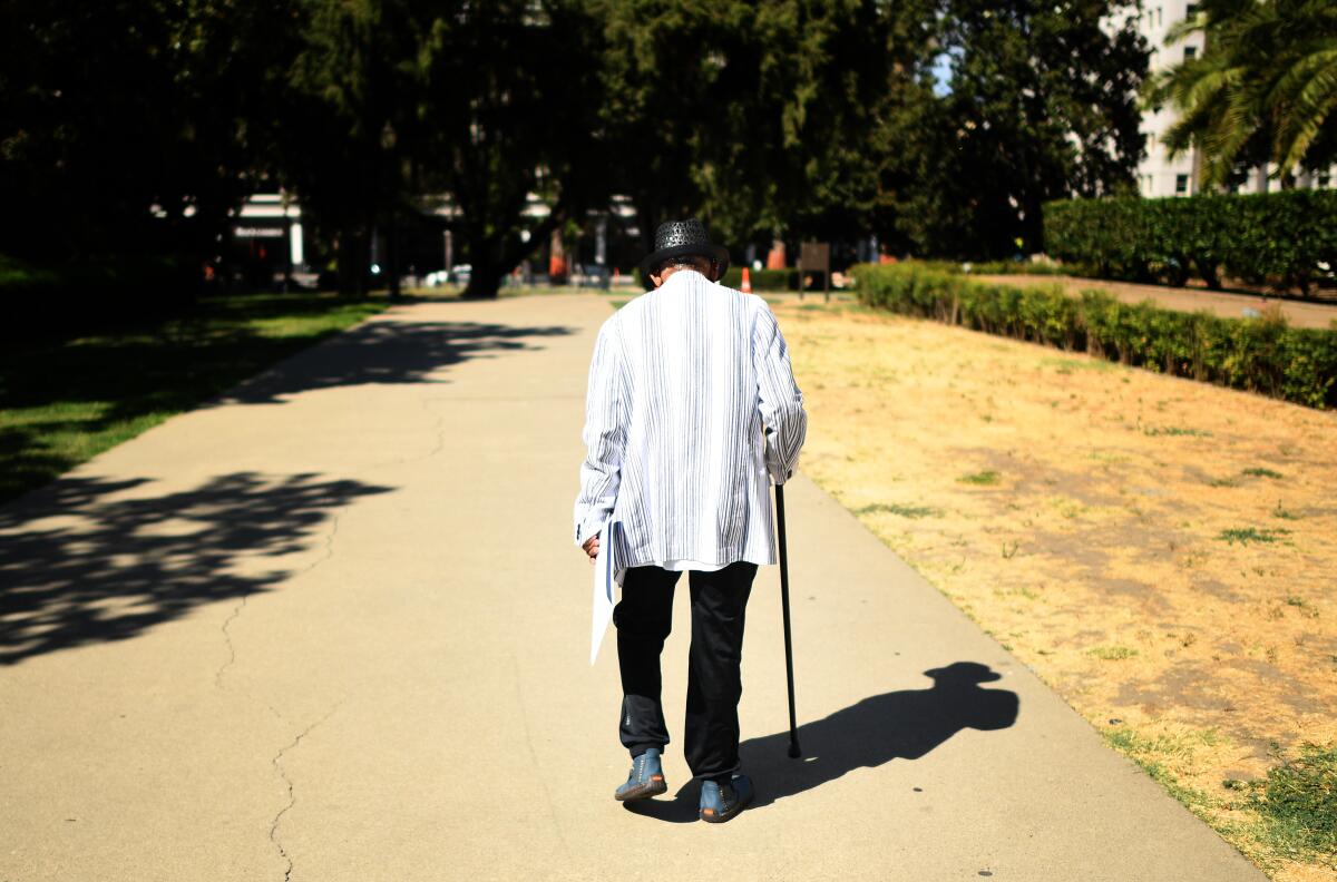 A man walks in front of the Capitol in Sacramento