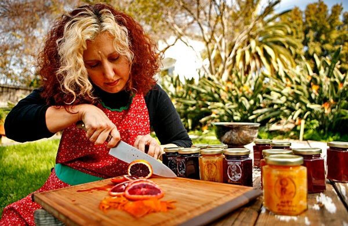 Laura Ann Masura cuts into a blood orange as she prepares one of her special jams.