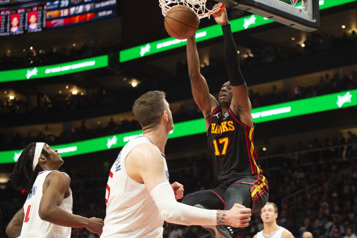 Atlanta Hawks forward Onyeka Okongwu (17) dunks during the second half of an NBA basketball game against the Los Angeles Clippers, Friday, March 11, 2022, in Atlanta. (AP Photo/Hakim Wright Sr.)
