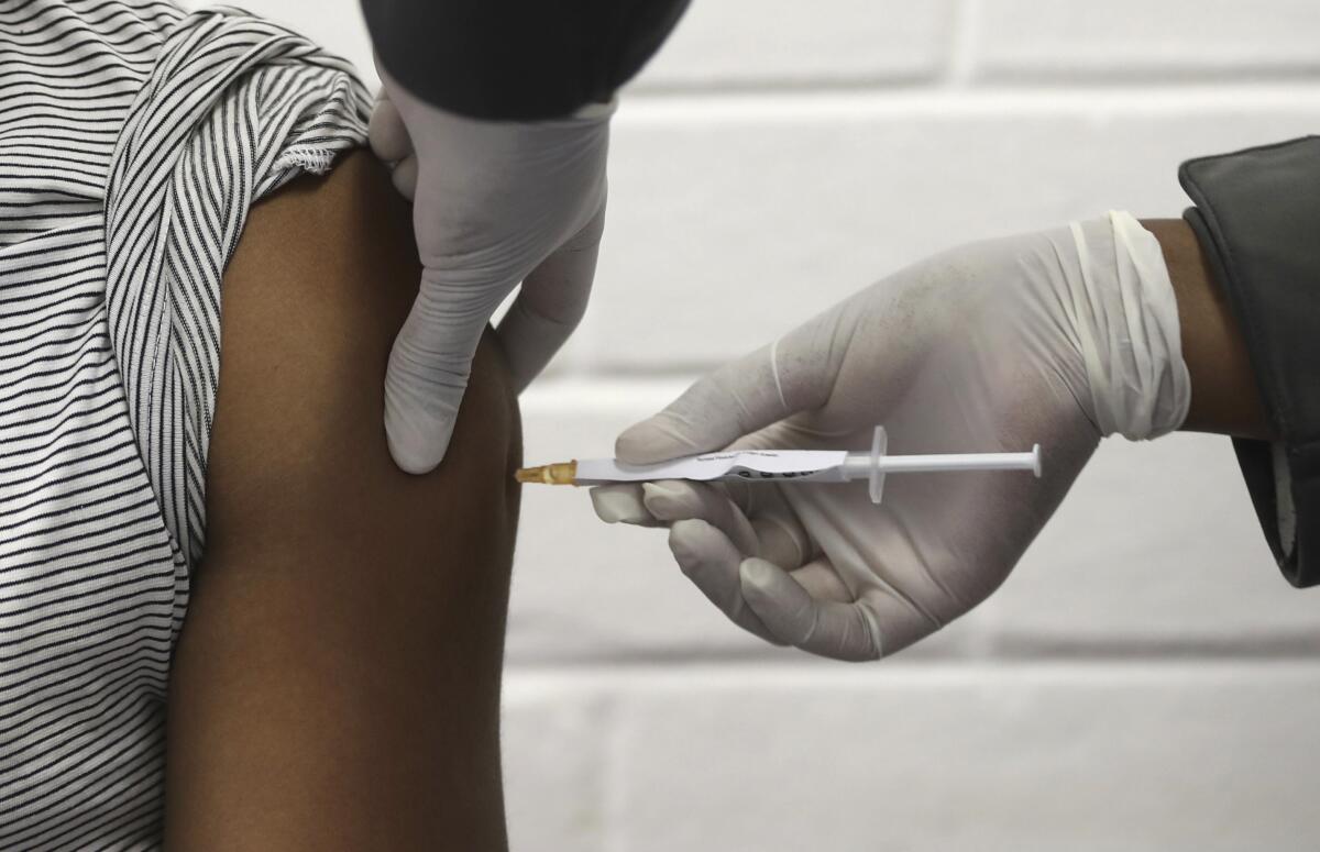 A volunteer in Johannesburg receives an injection as part of a COVID-19 vaccine trial.