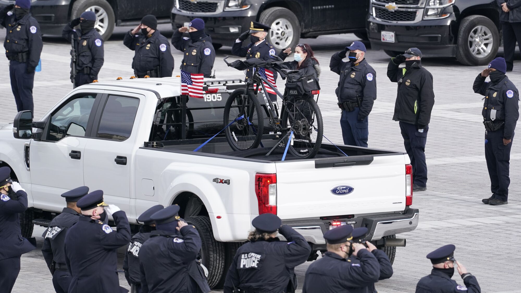 A truck carrying Sicknick's bike leaves the Capitol
