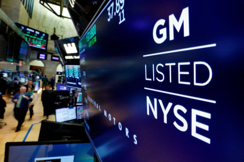 FILE - In this April 23, 2018, file photo, the logo for General Motors appears above a trading post on the floor of the New York Stock Exchange. General Motors reports earnings on Tuesday, April 23, 2024. (AP Photo/Richard Drew, File)