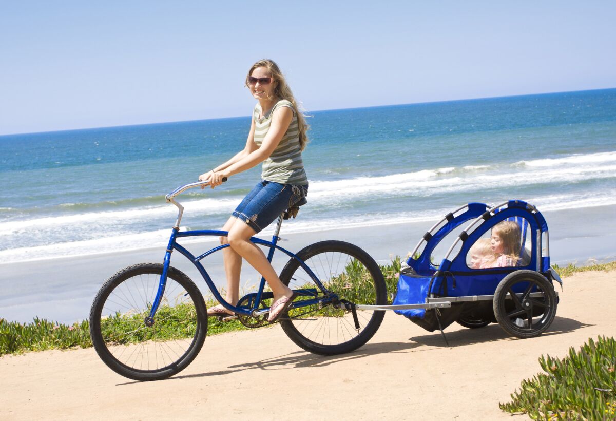 woman bicycling with child