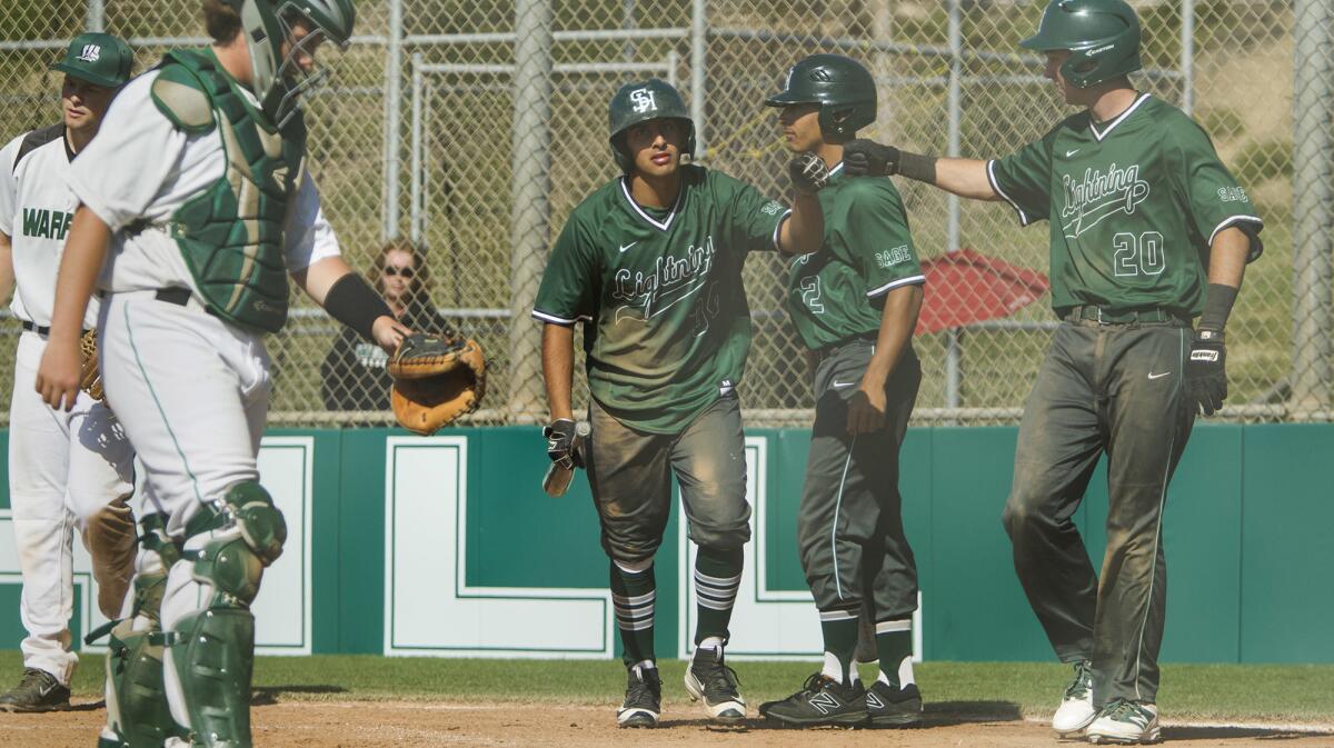 Sage Hill School's Ashwin Chona, center, is greeted at home plate by teammates Jack Pelc and Drake Mossman (20) after Chona hit a two-run homer during the fourth inning against Brethren Christian in an Academy League game on Thursday.