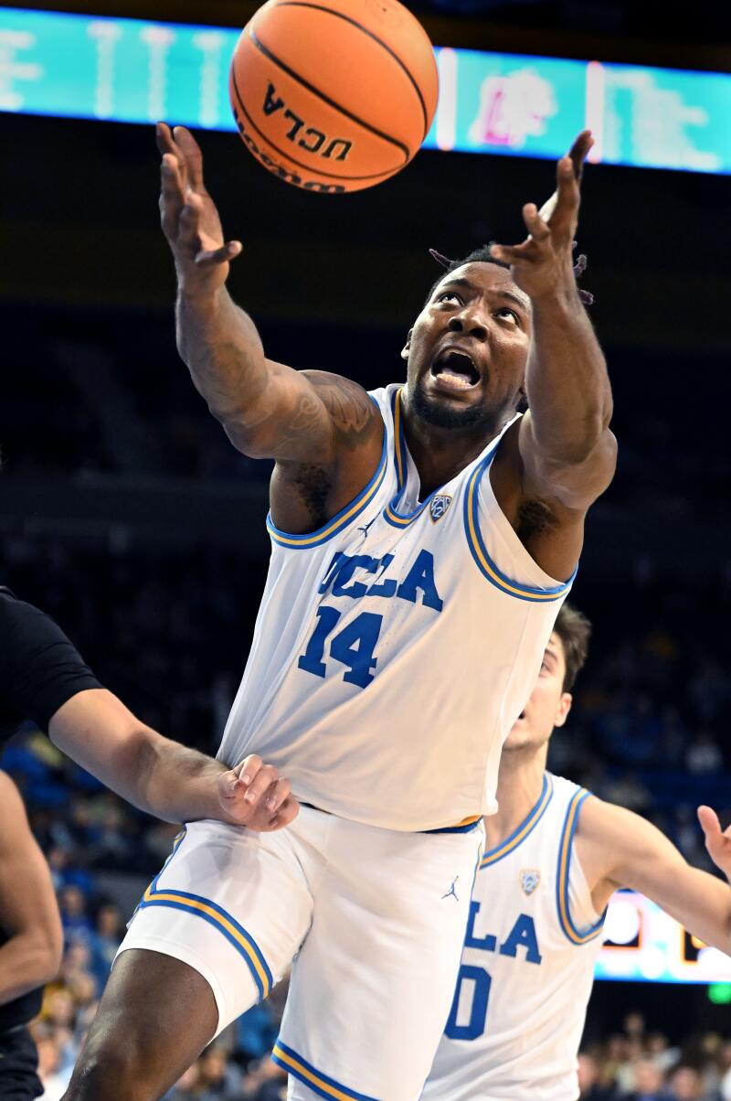 Los Angeles, California November 10, 2023-UCLA's Kenneth Nwuba grabs a rebound.