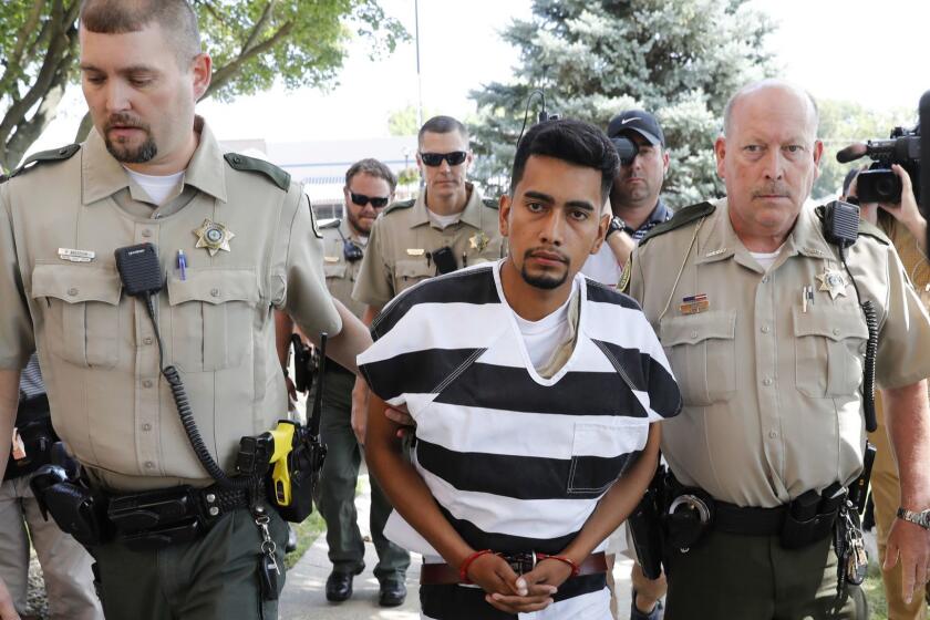 Cristhian Bahena Rivera is escorted into the Poweshiek County Courthouse for his initial court appearance, Wednesday, Aug. 22, 2018, in Montezuma, Iowa. Rivera is charged with first-degree murder in the death of Mollie Tibbetts, who disappeared July 18 from Brooklyn, Iowa. (AP Photo/Charlie Neibergall)