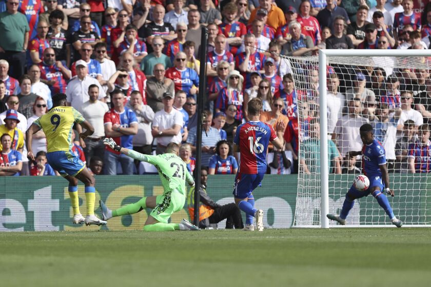 Nottingham Forest's Taiwo Awoniyi, left, scores his side's first goal of the game, during the English Premier League soccer match between Crystal Palace and Nottingham Forest, at Selhurst Park, in London, Sunday May 28, 2023. (Steven Paston/PA via AP)