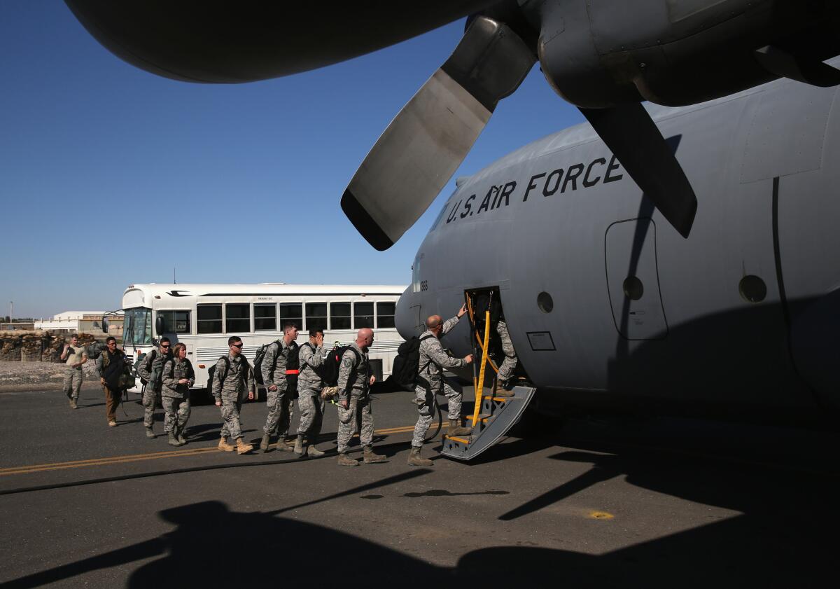 U.S. military personnel board a Texas Air National Guard C-130 cargo plane bound for Iraq on January 10, 2016 from a base in an undisclosed location in the Persian Gulf region.