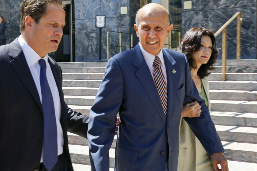 Former Los Angeles County Sheriff Lee Baca, center, leaves U.S. District Court this year after being accused of obstructing justice and lying to the federal government.
