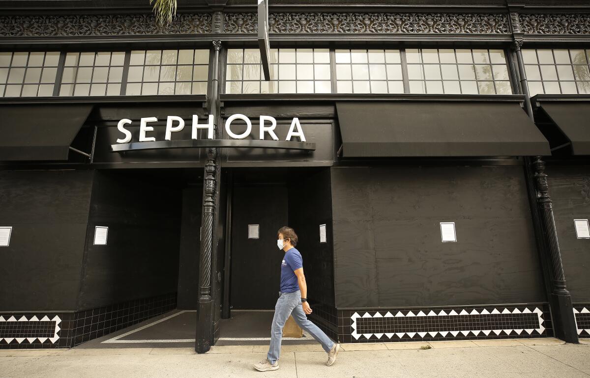 A pedestrian walks past a boarded-up Sephora store in Pasadena in April.