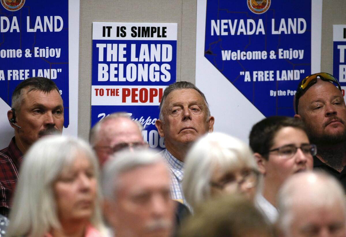 Nevada rancher Cliven Bundy, center, listens to testimony on a bill challenging federal control of Nevada public lands in a hearing at the Legislative Building in Carson City, Nev., Tuesday, March 31, 2015.