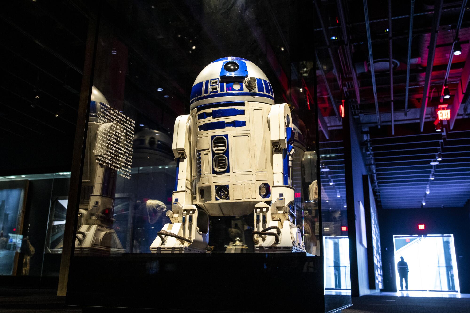 R2-D2 in a glass case in a museum.