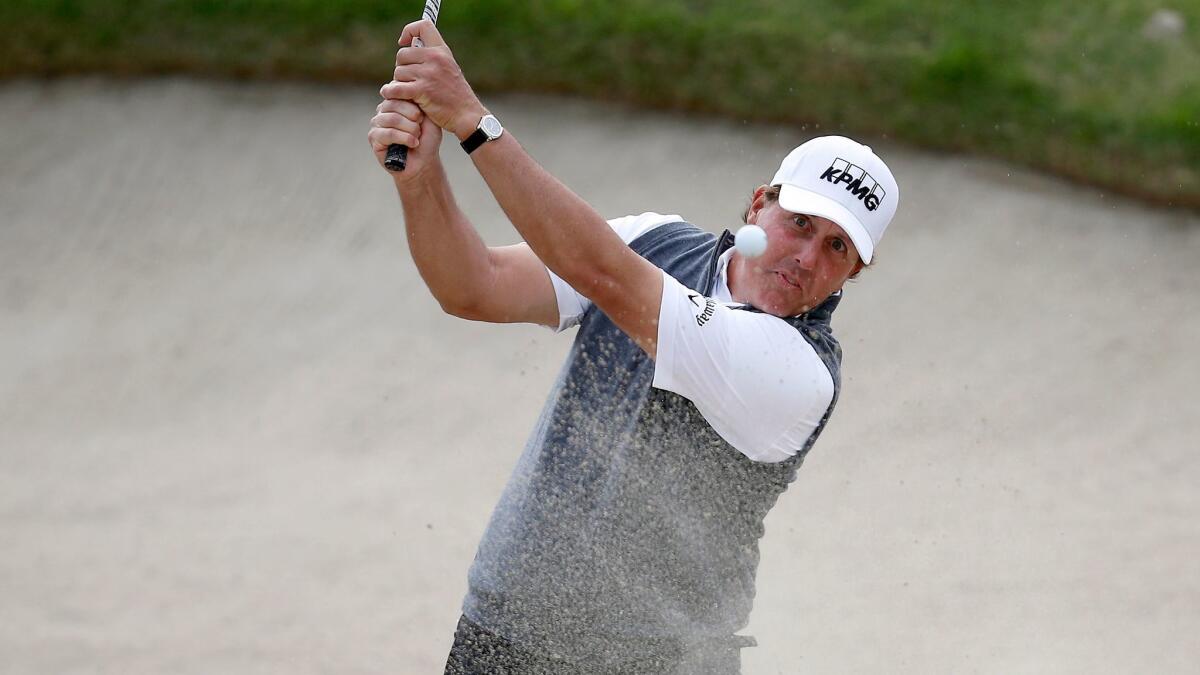 Phil Mickelson hits out of a bunker during the first round of the Genesis Open at Riviera Country Club on Feb. 16.