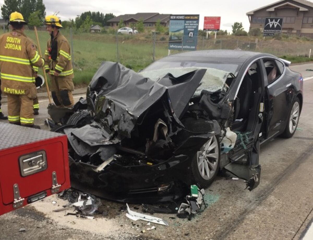 A crumpled Model S that crashed into a firetruck sits on Texas highway.