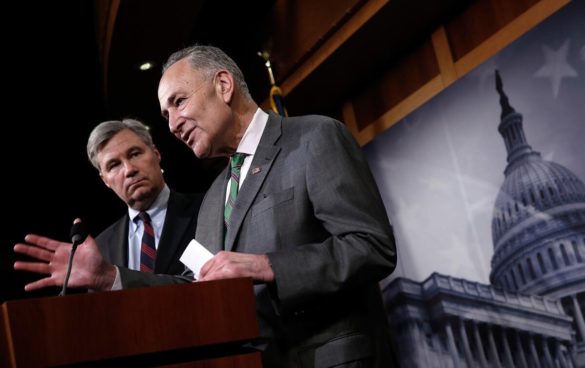 U.S. Sen. Charles Schumer (D-N.Y.), right, and Sen. Sheldon Whitehouse (D-R.I.) speak during a press conference at the Capitol on the Supreme Court's decision on campaign financing in McCutcheon vs. F.E.C.