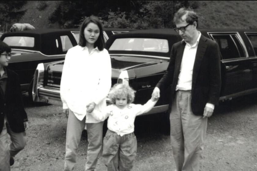 A photograph of Moses Farrow, Soon Yi Previn, Dylan Farrow and Woody Allen in a scene from "Allen V. Farrow." Credit: HBO