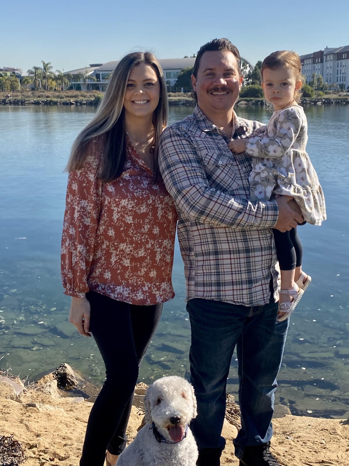 The Smith family (from left): Haley, Troy and Brynn, 2, with their dog, Blue, a 12-year-old Bedlington terrier