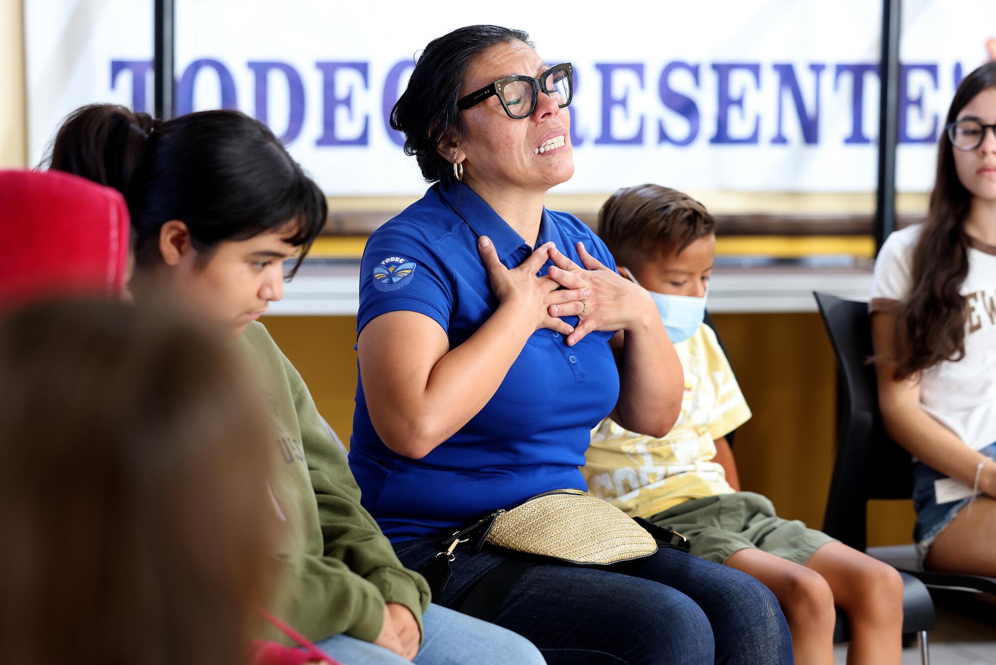 Executive Director Luz Gallegos, center, gets emotional while speaking to children about their love for their families.