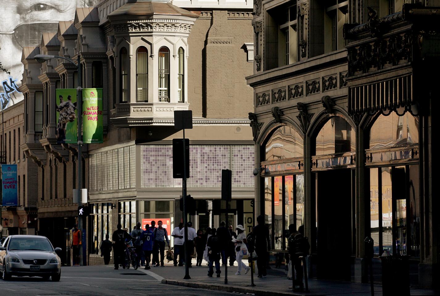 Pedestrians cross Main Street at the intersection of 5th Street in a downtown area known as "the corridor" that had the biggest jump in property crime in the LAPD's Central Division in the first half of 2015, a threefold increase compared with the same period last year.