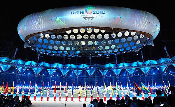 A giant tethered "aerostat" balloon bearing the Delhi 2010 logo hovers over Jawaharlal Nehru stadium in New Delhi.