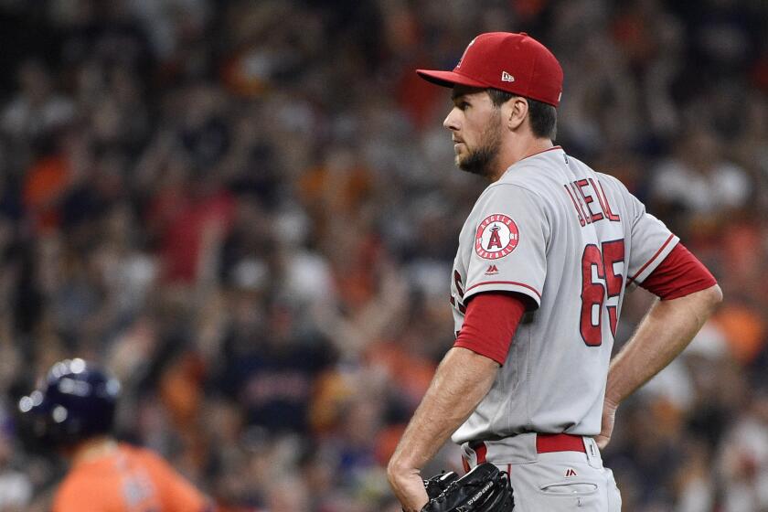 Los Angeles Angels relief pitcher Jake Jewell, right, backs off the mound as Houston Astros' Aledmys Diaz, back left, rounds the bases after hitting a three-run home run during the sixth inning of a baseball game Sunday, Sept. 22, 2019, in Houston. (AP Photo/Eric Christian Smith)