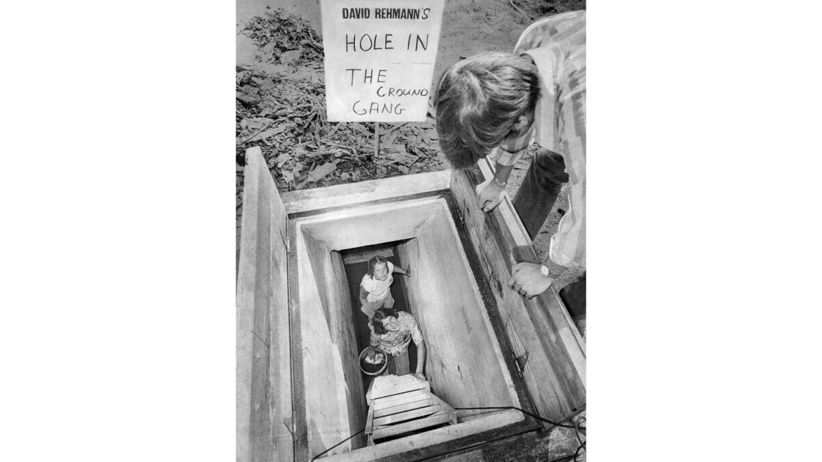 Aug. 23, 1974: Grant Ostapeck watches cleanup crew Hollye Draves and Mark Kehke climb the steps of an abandoned Garden Grove bomb shelter being converted into youth headquarters for congressional candidate David Rehmann.