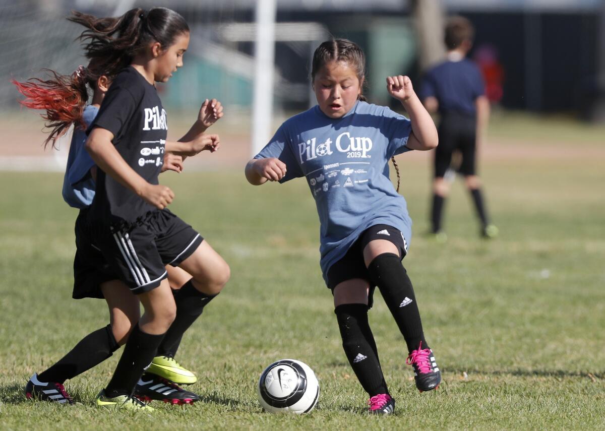 College Park Elementary's Kelsea Gayosso, right, plays against Rea's Elizabeth Garibay during a girls' third- and fourth-grade Bronze Division pool-play match at the Daily Pilot Cup on Wednesday at Jack R. Hammett Sports Complex in Costa Mesa.