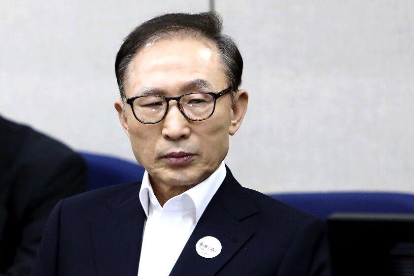 FILE - Former South Korean President Lee Myung-bak appears for his first trial at the Seoul Central District Court in Seoul, South Korea, March 23, 2018. South Korean prosecutors granted Lee a temporary release from prison over health concerns Tuesday, June 28, 2022, after he served less than three years of a 17-year sentence handed down for corruption. (Chung Sung-Jun/Pool Photo via AP, File)