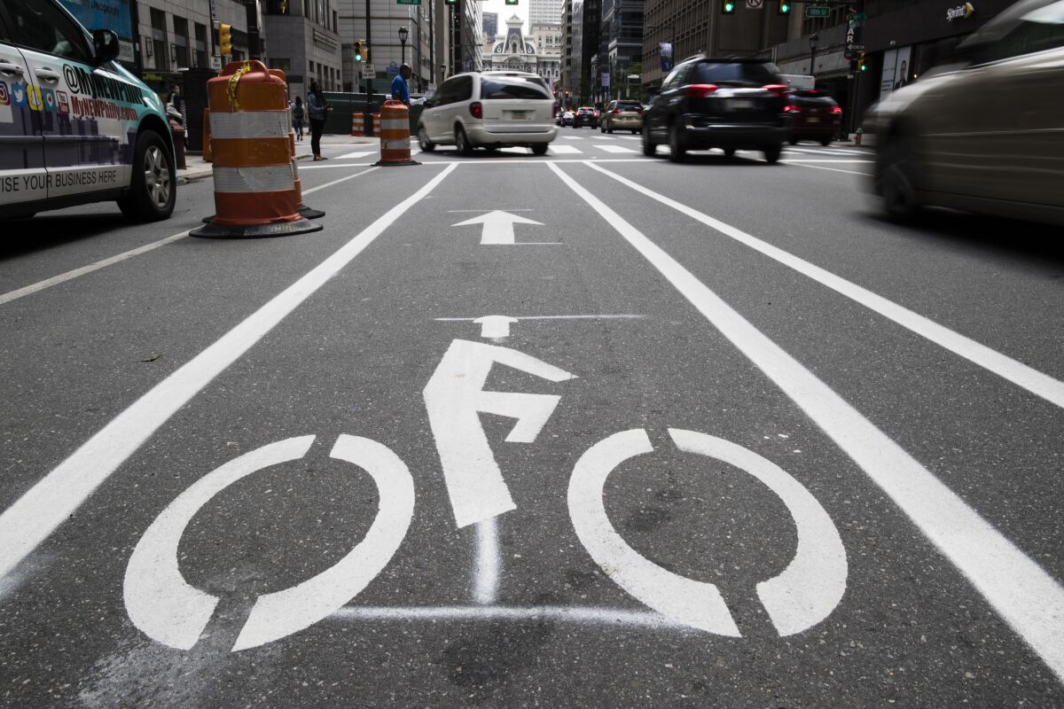 FILE - A bicycle lane along Market Street in Philadelphia, on June 4, 2018. The government has a fresh warning to states seeking billions of dollars from President Joe Biden's infrastructure law to widen roads: protect the safety of pedestrians and bicyclists or risk losing funds. In a new report submitted to Congress, the Transportation Department says it will now aim to prioritize the safety and health of all the users of a roadway, not just cars. (AP Photo/Matt Rourke, File)