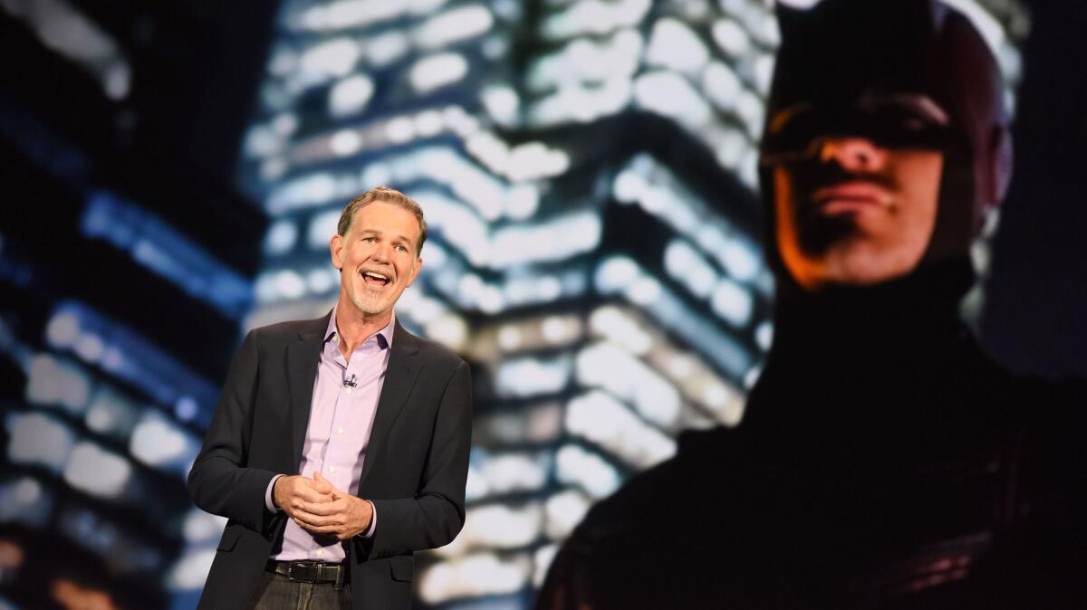 Netflix CEO Reed Hastings promotes one of his service's big successes, the series "Daredevil," at a 2016 conference.