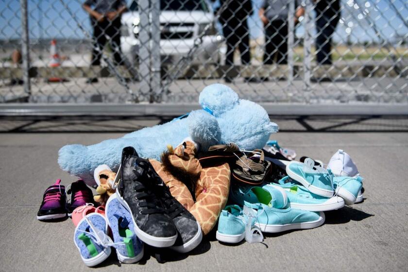 TOPSHOT - Security personal stand before shoes and toys left at the Tornillo Port of Entry where minors crossing the border without proper papers have been housed after being separated from adults, June 21, 2018 in Tornillo, Texas. President Donald Trump ordered an end to the separation of migrant children from their parents on the US border June 20, 2018, reversing a tough policy under heavy pressure from his fellow Republicans, Democrats and the international community. The spectacular about-face comes after more than 2,300 children were stripped from their parents and adult relatives after illegally crossing the border since May 5 and placed in tent camps and other facilities, with no way to contact their relatives. / AFP PHOTO / Brendan SmialowskiBRENDAN SMIALOWSKI/AFP/Getty Images ** OUTS - ELSENT, FPG, CM - OUTS * NM, PH, VA if sourced by CT, LA or MoD **