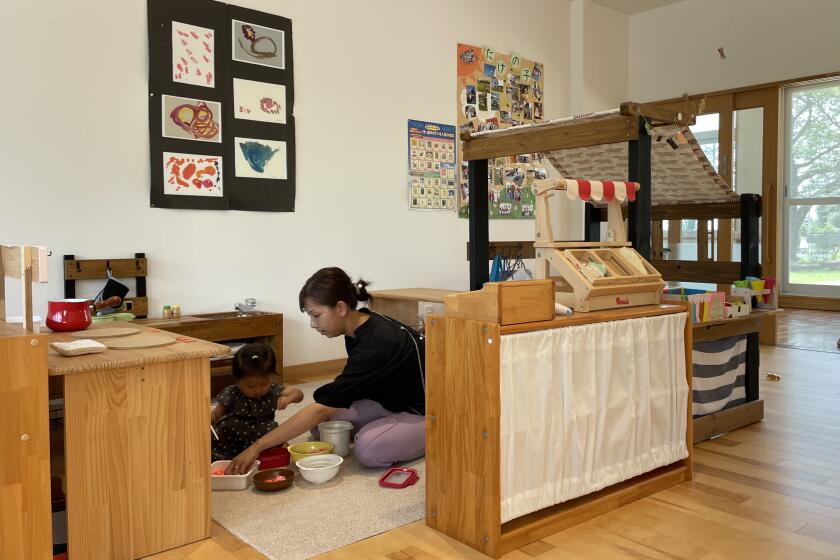 Takamoto, 37, plays with her 18 month old daughter at the Nagi Child Home