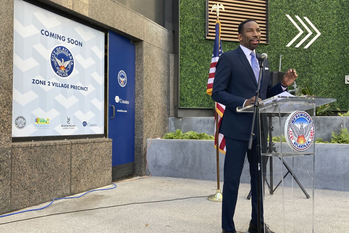 Atlanta Mayor Andre Dickens unveils a new police precinct in the Atlanta's Buckhead district Thursday, Jan. 13, 2022, as he tries to head off an effort to turn the wealthy, white enclave into its own city over concerns about a spike in crime. (AP Photo/Sudhin S. Thanawala)