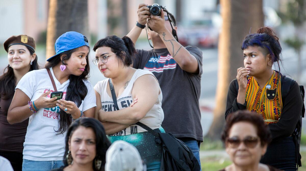 Maga Miranda, center, a member of Defend Boyle Heights, attends a community meeting at Pico Gardens in Boyle Heights.