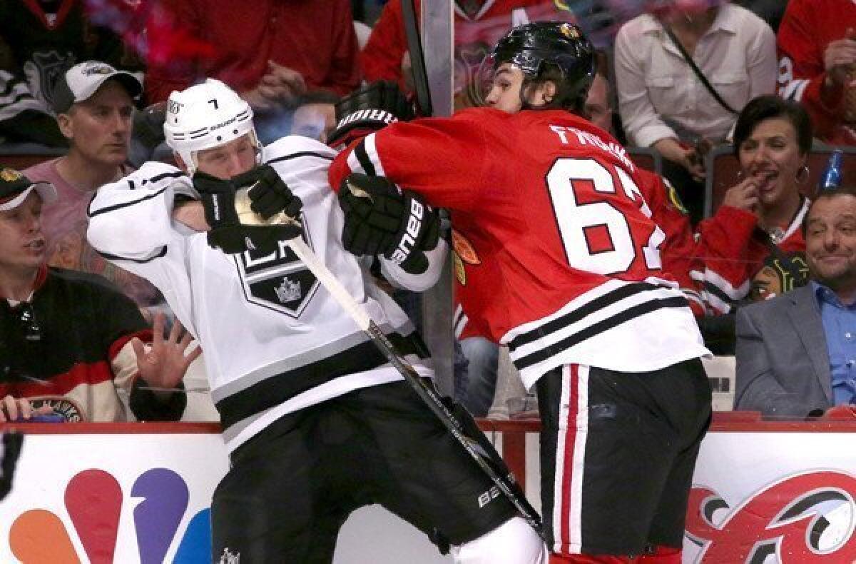 Blackhawks right wing Michael Frolik delivers a hit to Kings defenseman Rob Scuderi during a hard-hitting Game 1 on Saturday in Chicago.