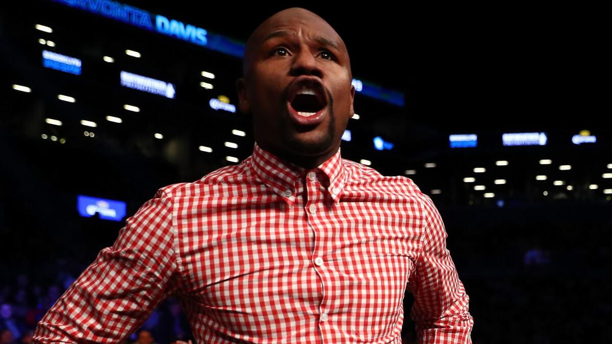Floyd Mayweather Jr. shouts instructions to Gervonta Davis during his fight against Jose Pedraza on Jan. 14.