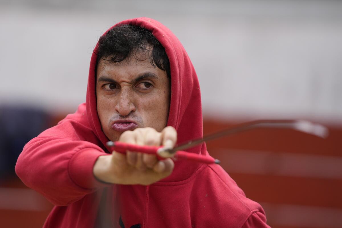 A Colombian bullfighter trains in a red hoodie.
