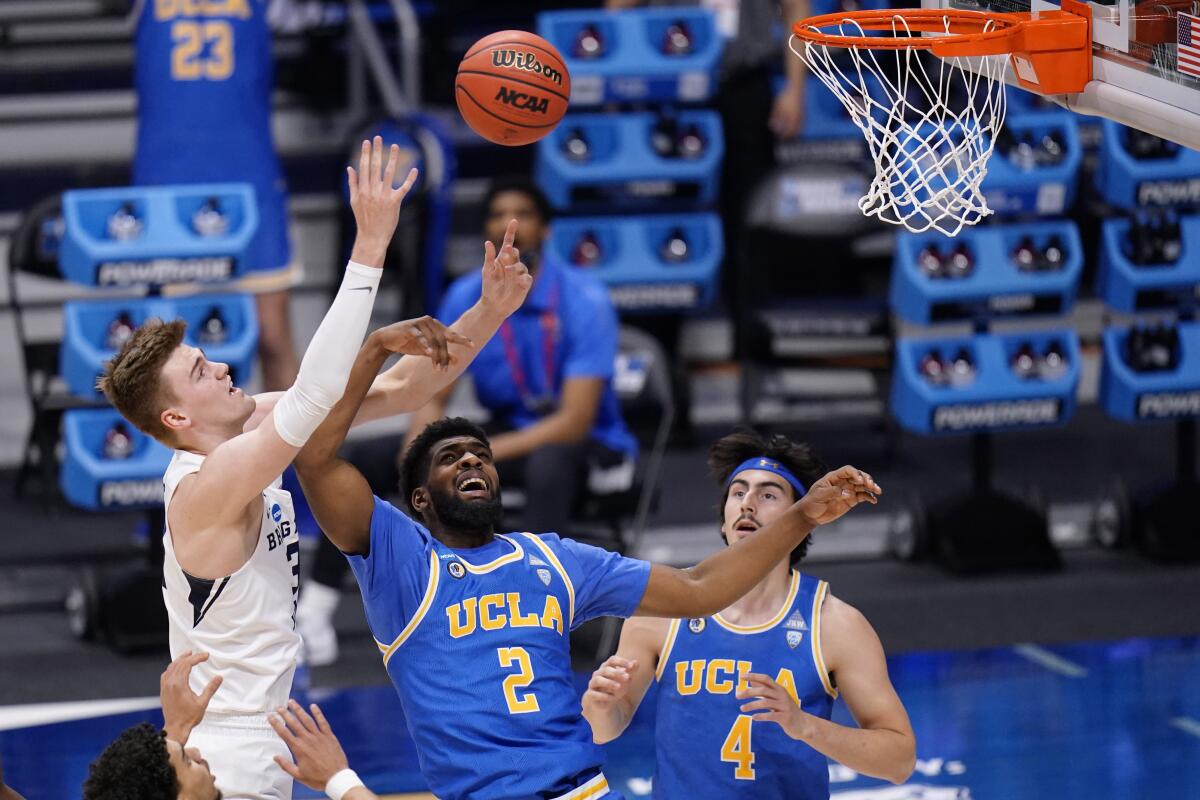 BYU forward Matt Haarms battles for a rebound with UCLA forward Cody Riley and teammate Jaime Jaquez Jr.