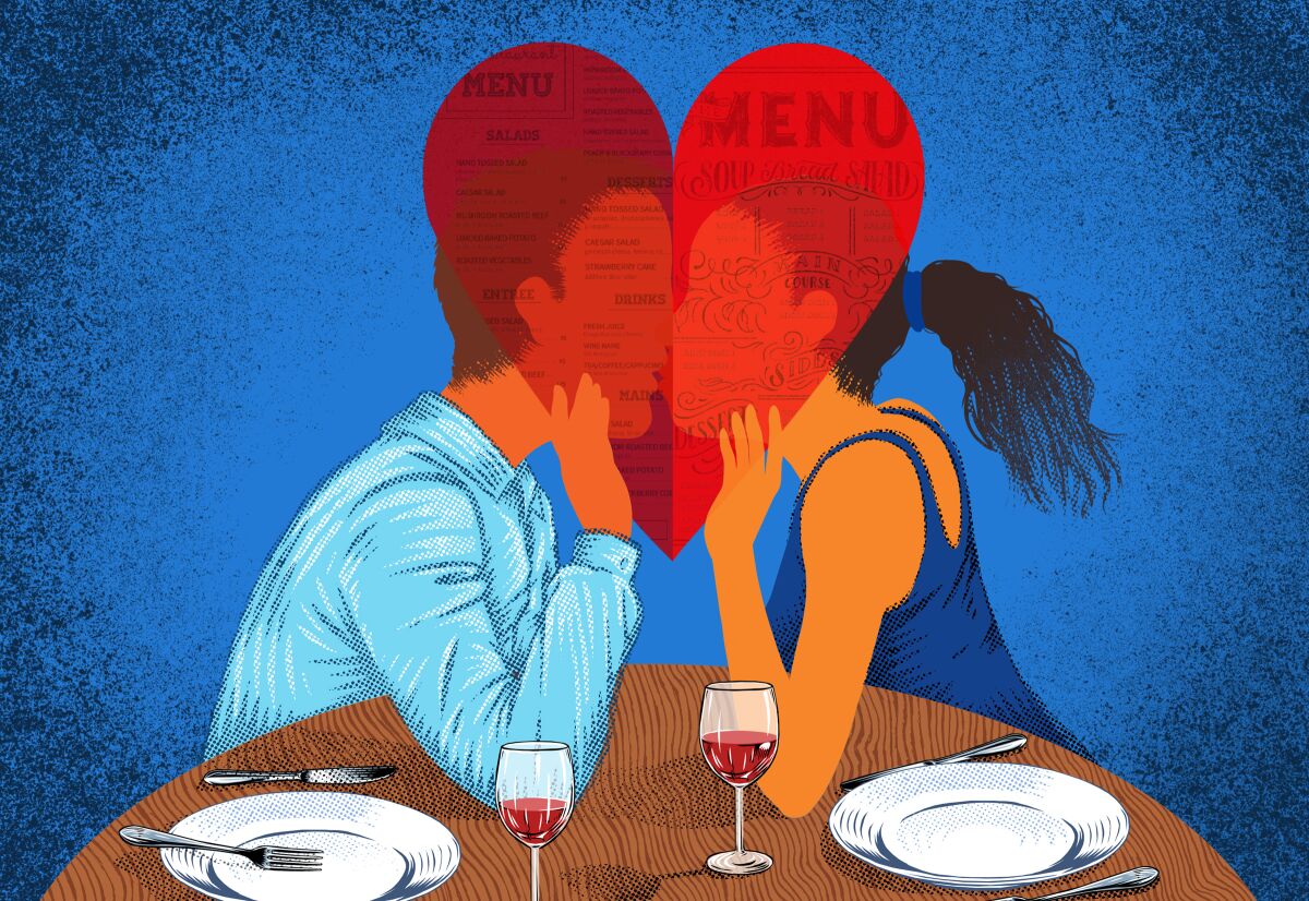 A couple share a kiss behind a menu shaped like a heart.