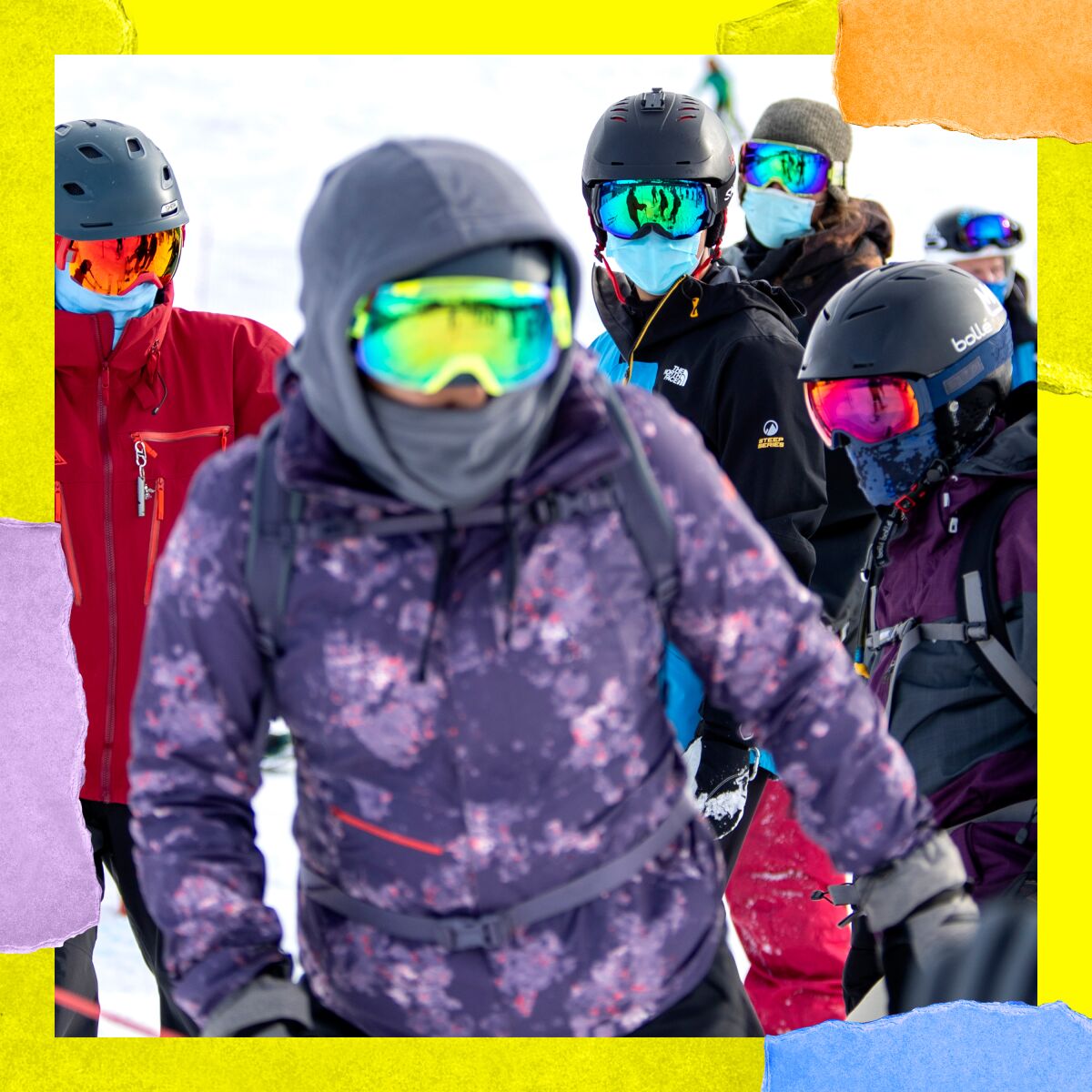 A crowd of people in ski gear, helmets and reflective goggles.