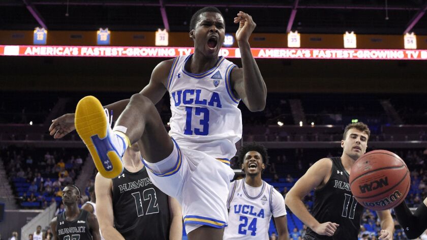 UCLA forward Kris Wilkes (13) reacts after dunking against Hawaii.